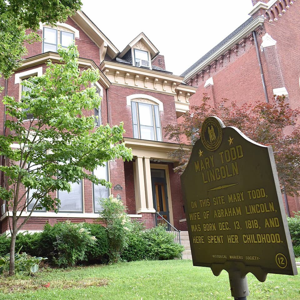 Historic marker for Mary Todd Lincoln in front of a Victorian-style house.